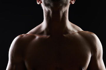 Image showing Chest, muscle and man on black background for fitness inspiration, beauty aesthetic or strong body motivation. Shadow aesthetic, male sports model or muscular bodybuilder in dark studio with lighting