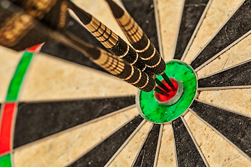 Image showing Three darts in bull's eye close up