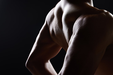 Image showing Man, back and shirtless in dark studio with shadow for wellness, health and strong by black background. Model guy, silhouette and fitness with skin, aesthetic and muscle with power in dark for art