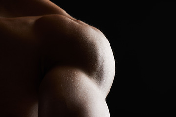 Image showing Shoulder, closeup and muscle of man in studio isolated on a black background mockup space. Body, strong and arm of model in fitness, bodybuilder power and workout for health, wellness and exercise