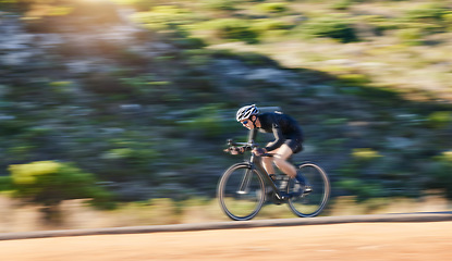 Image showing Motion blur, fitness and cyclist on bicycle on road in mountain with helmet, exercise adventure trail and speed. Cycling race, nature and man with bike for fast workout, training motivation or energy