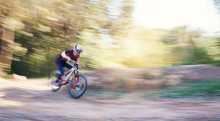 Image showing Blur, race and man cycling in nature training for a competition on trail in forest or woods. Action, sports or fast cyclist athlete riding bicycle at speed for cardio exercise, fitness or workout