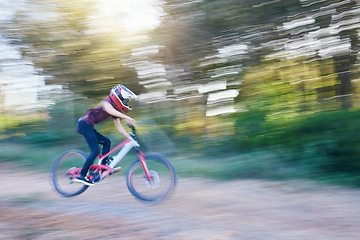 Image showing Blurred speed, sports and man cyclist on bicycle for race, competition or marathon training. Fitness, fast and athlete cycling on bike for workout, exercise or practice on a mountain road in nature.