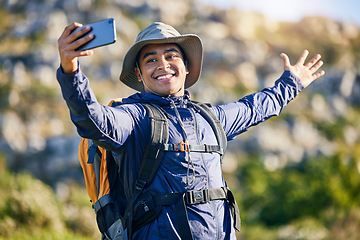 Image showing Selfie, smile and a man hiking in the mountains for travel, adventure or exploration in summer. Nature, freedom and photography with a happy young hiker taking a profile picture outdoor in the sun