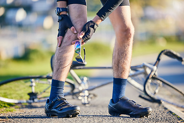 Image showing Man, cyclist and legs in knee injury, accident or pain after cycling exercise, fitness or outdoor workout on road. Closeup of male person or biker with sore bruise, inflammation or bicycle fall