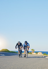 Image showing Competition, fitness and men on bicycle on road in nature with helmet, exercise adventure and speed. Cycling race, blue sky and cyclist race with bike for fast workout, training motivation and energy