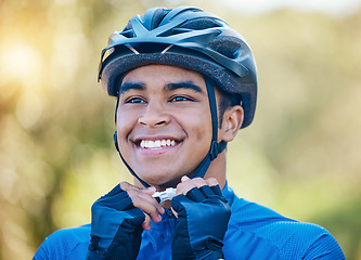 Image showing Exercise, cycling helmet and man outdoor for sports, workout or training with happy smile. Face of young athlete or cyclist with safety, wellness and fitness at park or thinking to start performance