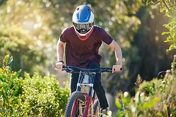 Image showing Fitness, nature and man cycling in training for a race competition on biking trail or woods. Action, sports or fast cyclist athlete riding bicycle at speed for cardio exercise, fitness or workout