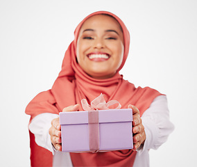 Image showing Woman, winner and gift box, offer or prize for giveaway and shopping on a white background. Muslim person in Saudi Arabia in portrait for present, ribbon package and winning or competition in studio