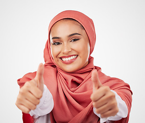 Image showing Muslim, woman and thumbs up, hands and agreement with smile in portrait isolated on white background. Hijab, opinion with communication and success, support and like emoji with vote in a studio