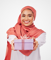 Image showing Woman, portrait and gift box, offer or prize for giveaway and shopping on a white background. Winner or muslim person in Saudi Arabia with present, ribbon package and winning or competition in studio