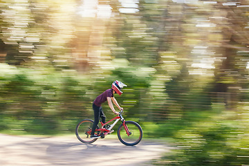 Image showing Blurred trees, sports and athlete cycling on bicycle for race, competition or marathon training. Fitness, fast and man cyclist riding a bike for speed practice challenge in mountain forest in nature.