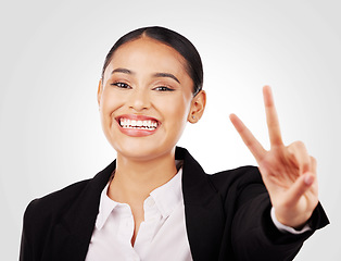 Image showing Happy business woman, portrait and peace sign in career ambition or positive mindset against a studio background. Face of female person or employee smile in happiness with emoji or hand gesture