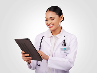 Image showing Happy woman, doctor and tablet in healthcare research, communication or Telehealth against a studio background. Female person, nurse or medical professional smile on technology for online networking