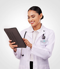 Image showing Happy woman, doctor and tablet in medical research, communication or Telehealth against a studio background. Female person, nurse or healthcare professional smile on technology for online networking