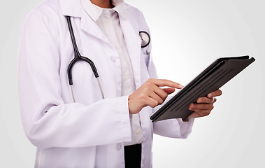 Image showing Doctor, hands and tablet in healthcare research, Telehealth or communication against a studio background. Closeup of medical person or professional on technology in online search or clinic results