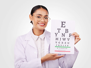 Image showing Woman, portrait and chart in eye exam, letter or vision of optometrist in healthcare or sight against a studio background. Happy doctor smile with glasses in optometry assessment, diagnosis or test