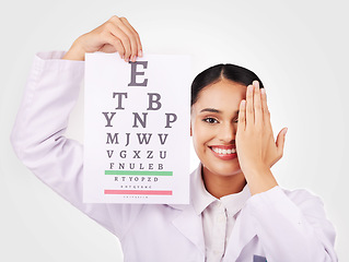 Image showing Portrait, smile and eye test with a woman optician in studio on a gray background for vision or eyesight. Face, medical and a happy young doctor in a clinic or optometry office for a visual exam