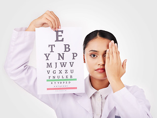 Image showing Portrait, poster and eye test with a woman optician in studio on a white background for vision or eyesight. Face, medical and a serious young doctor in a clinic or optometry office for a visual exam