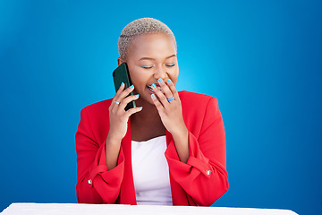Image showing Laughing, phone call and a woman in studio for communication, contact or conversation. Happy African person on a blue background with a smartphone for funny gossip chat, talking or networking