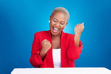 Image showing Business, excited and black woman with celebration, winning and success on a blue studio background. Person, model and entrepreneur with startup, happiness and victory with achievement and promotion