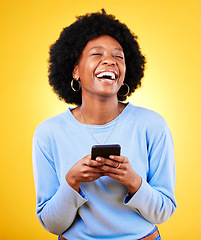 Image showing Woman, laugh and typing on smartphone in studio, reading funny social media post and mobile news on yellow background. Happy african model, cellphone and joke of meme, multimedia notification or tech