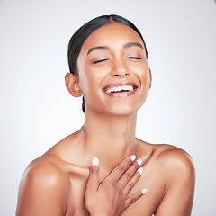 Image showing Face, beauty and smile with a woman laughing for health or wellness in studio on white background. Skincare, funny and cosmetics with a young model feeling happy or satisfaction about natural skin