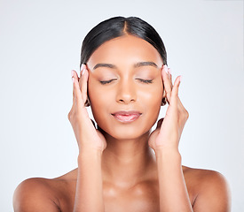Image showing Woman, face massage and beauty with skincare, dermatology and facial treatment in studio. Eyes closed, female model and wellness with soft, skin cosmetics and glow from makeup with white background