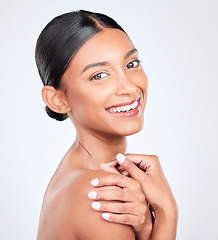 Image showing Portrait, happy woman and natural beauty in studio with healthy dermatology, aesthetic glow and shine on white background. Indian model, wellness and smile for pride in skincare, cosmetics and facial