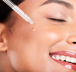 Image showing Closeup, woman and pipette with beauty, oil and dermatology with wellness on white studio background. Person, skincare product or model with hyaluronic acid, cosmetics or shine with serum and facial