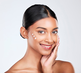 Image showing Portrait, cream and woman with skincare, beauty and dermatology on a white studio background. Face, person and model with lotion, shine and glow with cosmetics, moisturiser and smile with aesthetic