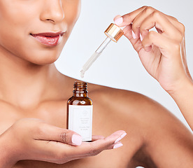 Image showing Oil serum in hands, woman and beauty with natural cosmetic product for skincare isolated on white background. Wellness, hyaluronic acid and liquid collagen for skin glow, pipette and bottle in studio