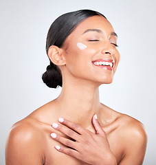 Image showing Smile, cream and woman with cosmetics, beauty and wellness on a white studio background. Person, happy or model with creme, moisturiser or aesthetic with self care, lotion or aesthetic with skincare