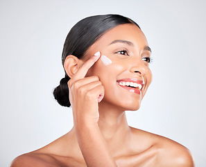 Image showing Smile, cream and woman with skincare, cosmetics or dermatology on a white studio background. Person, happy or model with creme, moisturiser or wellness with self care, beauty or aesthetic with lotion
