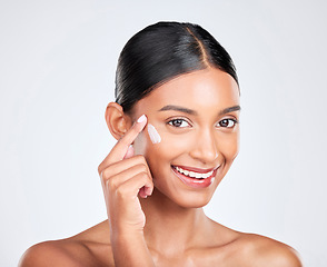 Image showing Portrait, cream and woman with skincare, cosmetics and moisturiser on a white studio background. Face, person and model with aesthetic, shine and glow with beauty, self care or dermatology with creme