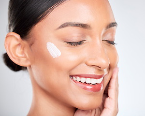 Image showing Smile, cream and woman with dermatology, wellness or self care with beauty on a white studio background. Person, happy or model with creme, cosmetics or moisturiser with skincare, aesthetic or lotion