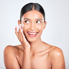 Image showing Woman, excited with cream on face and beauty, moisturizer and skincare isolated on white background. Cosmetics product, lotion or sunscreen with smile, facial and skin glow with dermatology in studio