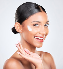 Image showing Portrait, cream and woman with cosmetics, dermatology and wellness on a white studio background. Face, person and model with lotion, skincare or glow with beauty, moisturiser and shine with aesthetic