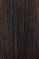 Image showing Background, textures and closeup of brown hair care, extensions and aesthetic cosmetics in beauty salon. Zoom in of long brunette hairstyle, wig and head with healthy shine, growth shampoo and color