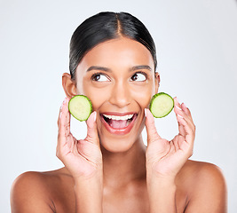 Image showing Face, excited and woman with cucumber, beauty and facial with natural skincare isolated on white background. Wellness, vegetable and vegan cosmetics product with glow, shine and green in studio