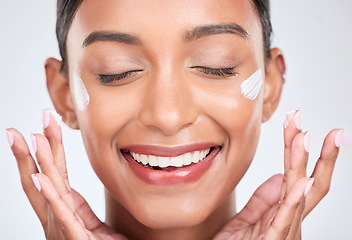 Image showing Happy, cream and woman with beauty, cosmetics or dermatology on a white studio background. Person, creme or model with moisturiser or wellness with self care, lotion or aesthetic with shine and glow