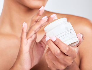 Image showing Skincare, closeup and woman with jar of face cream for cosmetic, natural and health routine. Wellness, beauty and zoom of model hands with dermatology spf, sunscreen or lotion by a studio background.