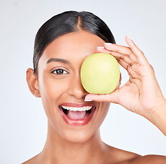 Image showing Apple, portrait and skincare of woman in studio for vitamin c benefits, natural cosmetics and nutrition on white background. Face of happy indian model, healthy beauty and green fruits for vegan diet