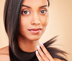 Image showing Hair care, beauty and portrait of woman in a studio with split ends for salon keratin treatment. Makeup, cosmetic and headshot of Indian female model with hairstyle isolated by a brown background.