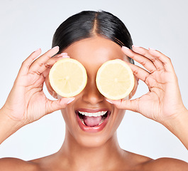 Image showing Skincare, lemon and woman with cosmetics, health and dermatology on a white studio background. Person, girl and model with fruit, vitamin c or nutrition with beauty, healthy skin or product with glow