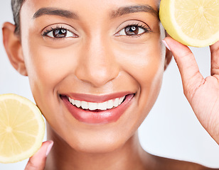 Image showing Lemon, fruit and portrait of Indian woman with skincare, beauty and benefits of vitamin c in eco friendly cosmetics in studio. Skin, care and face of model with natural dermatology and healthy fruits