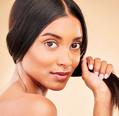 Image showing Strong hair, portrait and woman with beauty, self care and glow from collagen in shampoo or cosmetics on studio background. Indian, face and model with haircare, treatment or healthy texture or shine