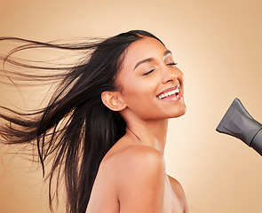 Image showing Woman, hair with dryer and wind, beauty and cosmetics tools with shine isolated on studio background. Heat treatment, keratin and wellness with straight hairstyle, electric appliance and growth