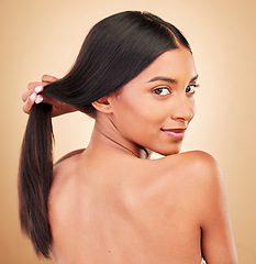 Image showing Strong hair, beauty and portrait of woman with self care and glow from collagen in shampoo or cosmetics on studio background. Indian, face and model with haircare, treatment or healthy texture