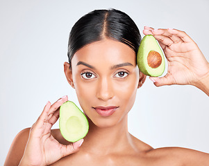 Image showing Portrait, avocado and woman with natural beauty, facial and eco friendly skincare isolated on white background. Wellness, dermatology and vegan cosmetics product with glow, shine and green in studio